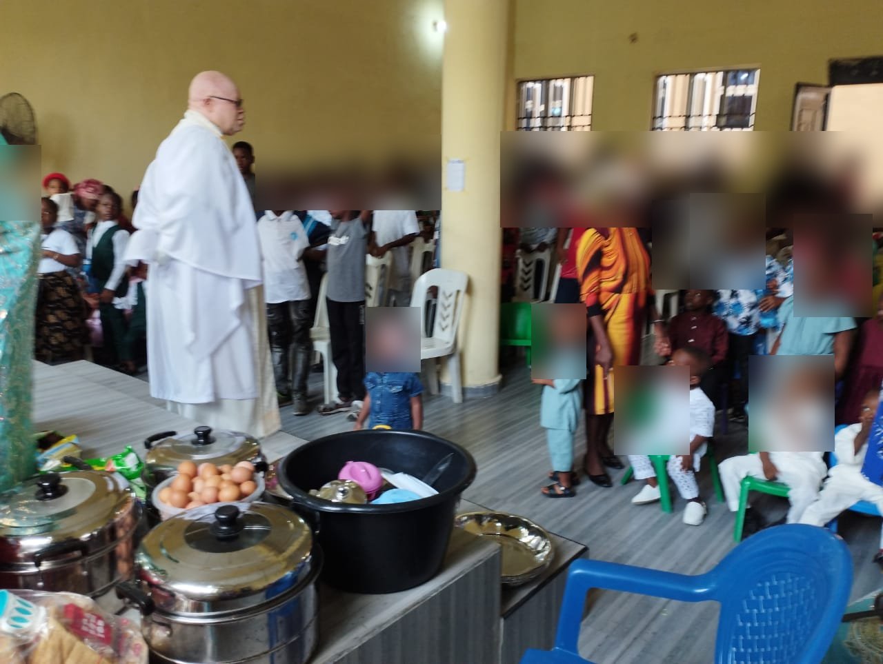 Children and clergy at a church service supported by HCCO