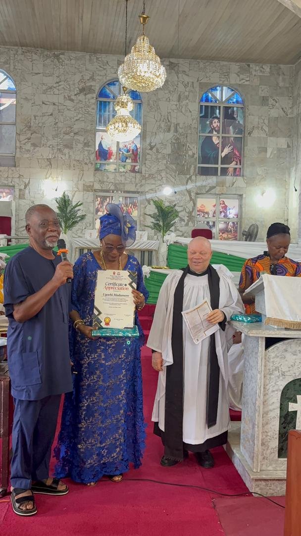 Ugochi Madumere receiving a certificate of appreciation from a partner church